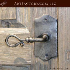 decorative iron lever pull on rustic two panel wooden door