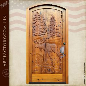 hand carved cabin door with moose antler door pull