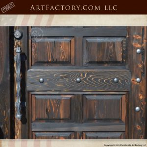 raised panel wood door with custom medieval castle door handle
