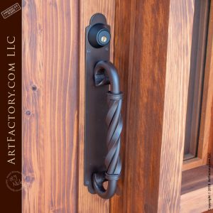 eyebrow arched speakeasy door with twisted c-shaped wrought iron door pull
