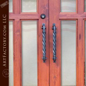 semi arched double glass panel doors with twisted c-shaped wrought iron door pulls