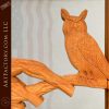 hand carved owl on tree branch