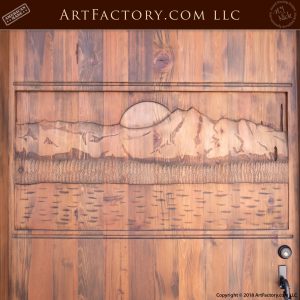 lakeside carved wood scene on door up close with setting sun behind the mountains overlooking the lake