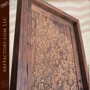 close up of apple blossom wood carving on door