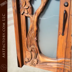 base of tree carved design on solid wood door close up