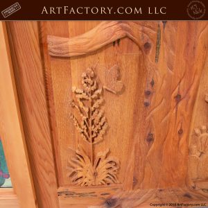 hand carved plants on wooden door up close