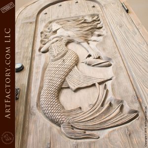 mermaid word carving on door close up